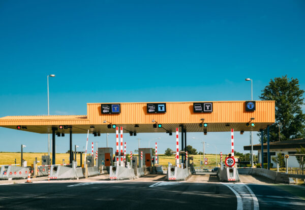 Cars Passing Through The Automatic Point Of Payment On A Toll Road. Point Of Toll Highway, Toll Station. Highway Toll Plaza Or Turnpike Or Charging Point, Entrance On Motorway.