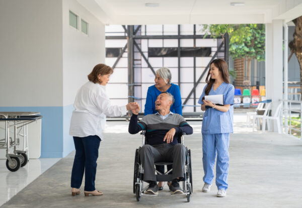Doctor consulting senior man at hospital. Medical staff explaining diagnosis to patient. Medicine and healthcare concept.