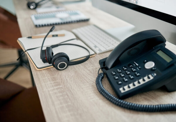 Telemarketing office, phone and VOIP on desk for communication, contact us and consulting by comput.